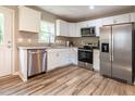 Modern kitchen with stainless steel appliances, granite countertops, and bright white cabinetry at 522 E Club Blvd, Durham, NC 27704