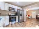 Open kitchen featuring modern appliances, granite counters, and a view to the living area at 522 E Club Blvd, Durham, NC 27704