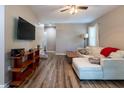 Inviting living room features a comfortable sofa, modern TV, and stylish wood-look floors at 522 E Club Blvd, Durham, NC 27704