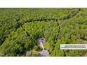 Aerial view of a home nestled within a lush, green, densely wooded area at 62 Mountain Laurel Ln, Four Oaks, NC 27524