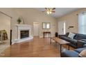 Living room featuring hardwood floors, vaulted ceilings, and a corner fireplace at 62 Mountain Laurel Ln, Four Oaks, NC 27524