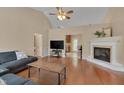 Spacious living room with wood floors, vaulted ceiling, fireplace and ample natural light at 62 Mountain Laurel Ln, Four Oaks, NC 27524