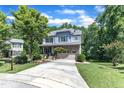Beautiful two-story home with blue siding, a stone foundation, and a lush green lawn at 6509 Conaway Ct, Wake Forest, NC 27587