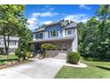 Charming two-story house featuring stone and siding, with a spacious driveway and lawn at 6509 Conaway Ct, Wake Forest, NC 27587