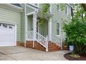 Charming front porch with brick steps and white wooden railing at 709 Bonhurst Dr, Holly Springs, NC 27540