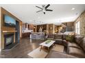 Open-concept living area boasts a fireplace, leather sectional sofa, and seamlessly connects to the kitchen at 744 Birch Arbor Cir, Raleigh, NC 27604