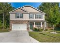 Charming two-story home showcasing stone accents, green shutters, and a well-manicured lawn at 98 Panmure, Rocky Mount, NC 27804