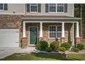 Inviting front porch with stone accents, decorative columns, and a well-maintained lawn at 98 Panmure, Rocky Mount, NC 27804