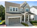Attractive home featuring neutral siding, an attached garage, and a welcoming covered entryway at 98 Stone Bridge Xing # 98, Chapel Hill, NC 27517