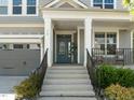 Inviting front entrance with a teal-colored door, decorative sidelights, and a covered porch at 98 Stone Bridge Xing # 98, Chapel Hill, NC 27517