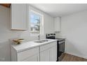 Clean kitchen design with marble countertops, bright white cabinets, and new appliances at 1006 E Harnett St, Dunn, NC 28334