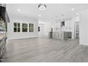 Bright living room features a stone fireplace and transitions to a modern kitchen at 107 Mohave Dr, Louisburg, NC 27549