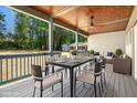 Covered back porch with an outdoor dining table and ceiling fan at 107 Mohave Dr, Louisburg, NC 27549