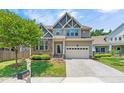 Stunning home with stone accents, lush landscaping, and an attached two-car garage on a sunny day at 118 Fox Run Ct, Durham, NC 27705