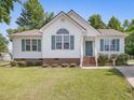 Attractive single-Gathering home with green shutters and a well-kept lawn at 1230 Piney Glen Ln, Zebulon, NC 27597