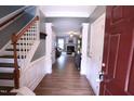 Inviting foyer with wood floors, staircase, and open view into the spacious living area at 126 Willow Weald Ct, Fuquay Varina, NC 27526