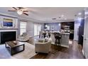 Open-concept living area with a fireplace, bar seating, and dining space at 126 Willow Weald Ct, Fuquay Varina, NC 27526