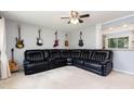 Spacious living room featuring an oversized leather sectional and unique guitar wall decor at 141 Weston Rd, Garner, NC 27529