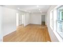 Spacious living room with light wood floors, white walls, and ample natural light at 1605 Bobwhite Ln, Rocky Mount, NC 27804