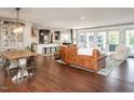 Open-concept living room featuring hardwood floors, modern furnishings, and a seamless flow to the kitchen at 1625 Haystack Ln, Burlington, NC 27217