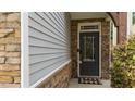 Close-up of the front door featuring stone accents and a 'welcome' mat at 2057 Tanners Mill Dr, Durham, NC 27703