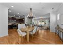 Open living space with hardwood floors and connecting kitchen and dining area at 2057 Tanners Mill Dr, Durham, NC 27703