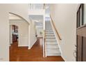 Elegant foyer featuring hardwood floors and a staircase leading to the upper level at 210 Strolling Way, Durham, NC 27707