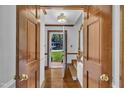 Inviting entryway featuring hardwood floors and decorative wood doors on either side at 2204 Basil Drive, Raleigh, NC 27612