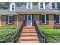 Inviting brick entryway with decorative black railings leading to the front door at 2204 Basil Drive, Raleigh, NC 27612