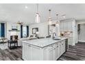 Modern kitchen featuring a spacious island with seating, stainless steel appliances, and sleek finishes at 2516 Del Webb Gardens Dr, Fuquay Varina, NC 27526