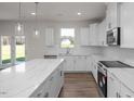 Modern kitchen with a large island, stainless steel appliances, and ample counter space at 267 Old Fashioned Way, Lillington, NC 27546