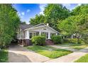 Charming home featuring a welcoming front porch, classic architectural details, and a well-maintained lawn at 306 Union Ave, Burlington, NC 27217
