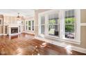 Bright and airy living room boasts hardwood floors, fireplace, and lots of natural light from the large windows at 306 Union Ave, Burlington, NC 27217
