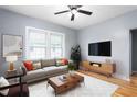 Cozy living room with a modern sofa, decorative pillows, wood furniture, rug and hardwood floors at 307 W Austin St, Mebane, NC 27302
