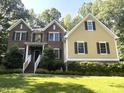 Beautiful two-story home with brick and siding exterior, a well-manicured lawn, and mature trees at 3650 Pleasants Ridge Dr, Wake Forest, NC 27587