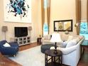 Spacious living room featuring hardwood floors, tall curtains, and comfortable seating arrangements at 3650 Pleasants Ridge Dr, Wake Forest, NC 27587