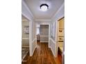 Hallway with hard wood floors, neutral paint, and access to rooms and storage at 3832 Doeskin Dr, Apex, NC 27539