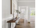 Inviting entryway with hardwood floors, stylish console table, and clear view of the front door with sidelights at 427 Bluffberry Way, Hillsborough, NC 27278
