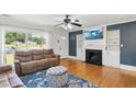 Cozy living room featuring hardwood floors, a fireplace, and natural light at 492 N Dunn St, Angier, NC 27501