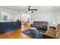 Open-concept living room with hardwood floors and view to the kitchen and dining areas at 492 N Dunn St, Angier, NC 27501