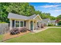 Quaint single-story home with a welcoming front porch and neat landscaping along the walkway at 512 Wyndham Dr, Fuquay Varina, NC 27526