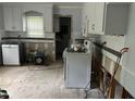 Kitchen shows potential with white cabinets and a window, ready for customization and updates at 5816 Henner Pl, Durham, NC 27713