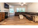 Comfortable living room with a fireplace, TV, and large sectional sofa at 6206 Braidwood Court Ct, Raleigh, NC 27612