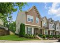 Charming two-story townhome features craftsman architecture, complemented by lush landscaping and a well-maintained lawn at 6236 Pesta Ct, Raleigh, NC 27612