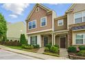 Beautiful two-story townhome showcasing inviting curb appeal with a well-manicured lawn and craftsman-style facade at 6236 Pesta Ct, Raleigh, NC 27612