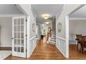 Elegant foyer featuring hardwood floors, a staircase, decorative moldings, and ample natural light at 712 Brittley Way, Apex, NC 27502