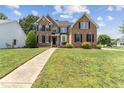 Beautifully maintained front yard and charming brick house with mature landscaping at 712 Brittley Way, Apex, NC 27502