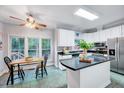 Bright kitchen with stainless steel appliances, island, and a cozy breakfast nook at 838 Joyner Ct, Wake Forest, NC 27587