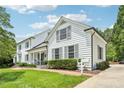 Well-maintained home with classic architectural details and lush green lawn at 1004 E Willowbrook Dr, Burlington, NC 27215