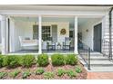 Inviting front porch featuring a porch swing and classic rocking chairs at 1004 E Willowbrook Dr, Burlington, NC 27215